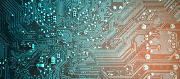 Close-up view of a computer circuit board with intricate pathways and components, shown in teal and orange lighting.
