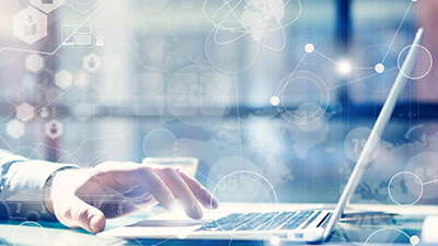 A person typing on a laptop with an overlay of digital and technological icons, including network connections, hexagons, and abstract data symbols, set against a blurred background.