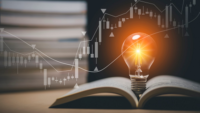 An open book with a glowing light bulb resting on top, symbolizing ideas or learning, with stacks of books in the background and overlaid stock market charts including candlestick patterns and trend lines.