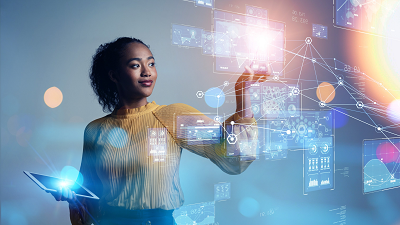 A person holding a tablet in one hand while interacting with a holographic interface using the other, displaying data visualizations, charts, and network connections.